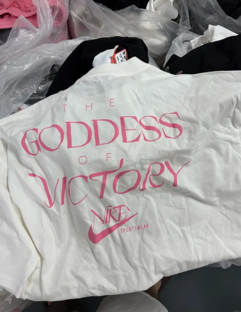Back of a white T-shirt with large pink lettering