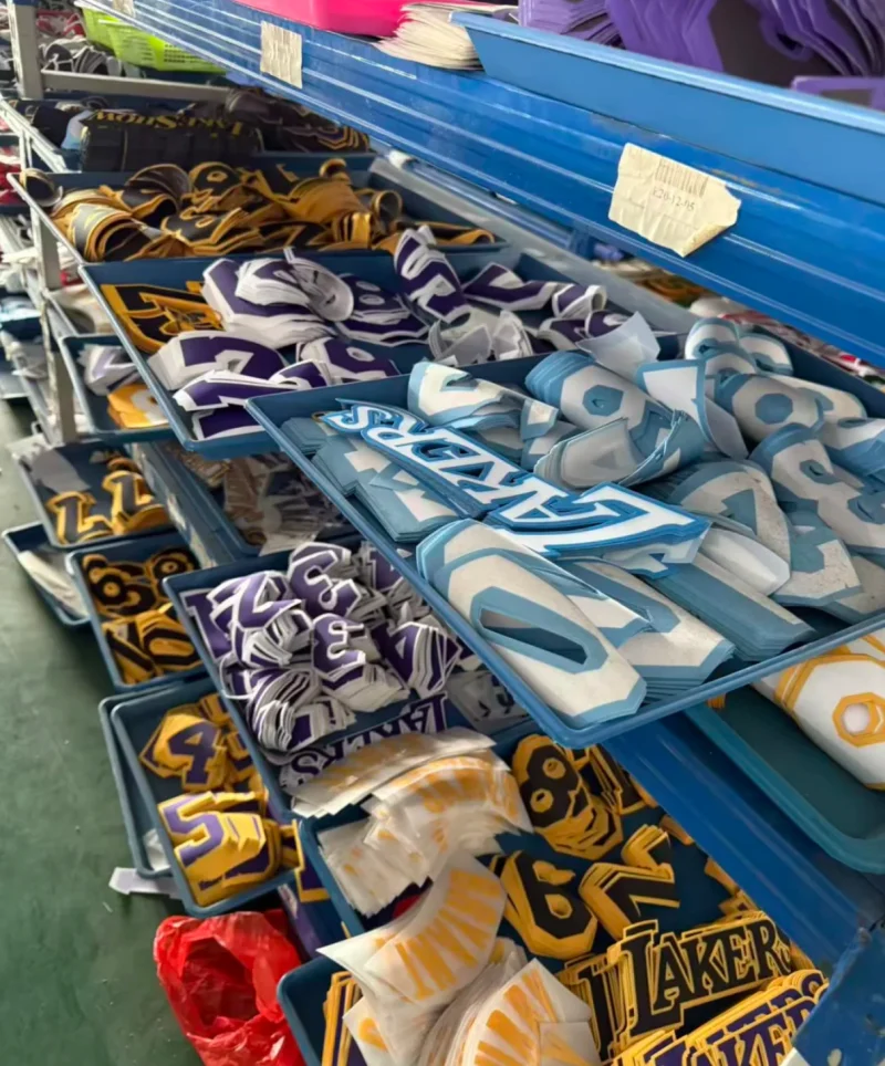 Rows of blue trays on shelving containing lettering and numbers in several colours