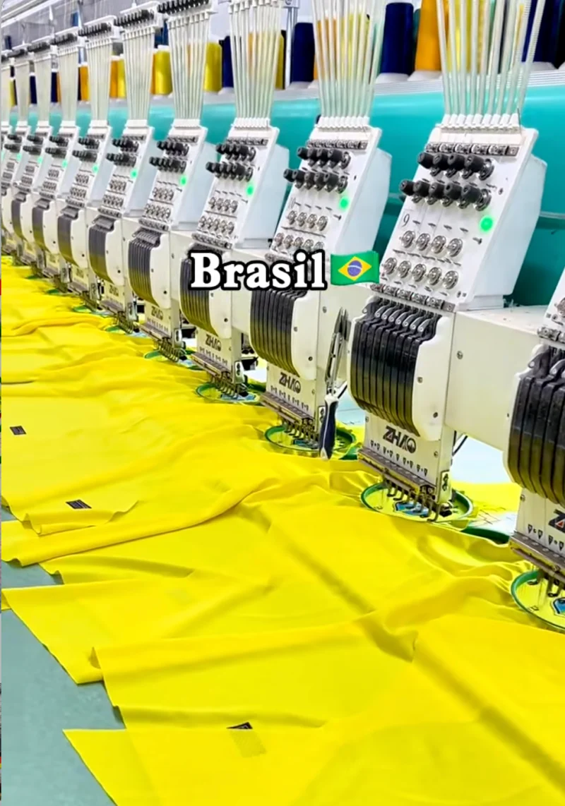 Multi-head embroidery machines working on yellow fabric.