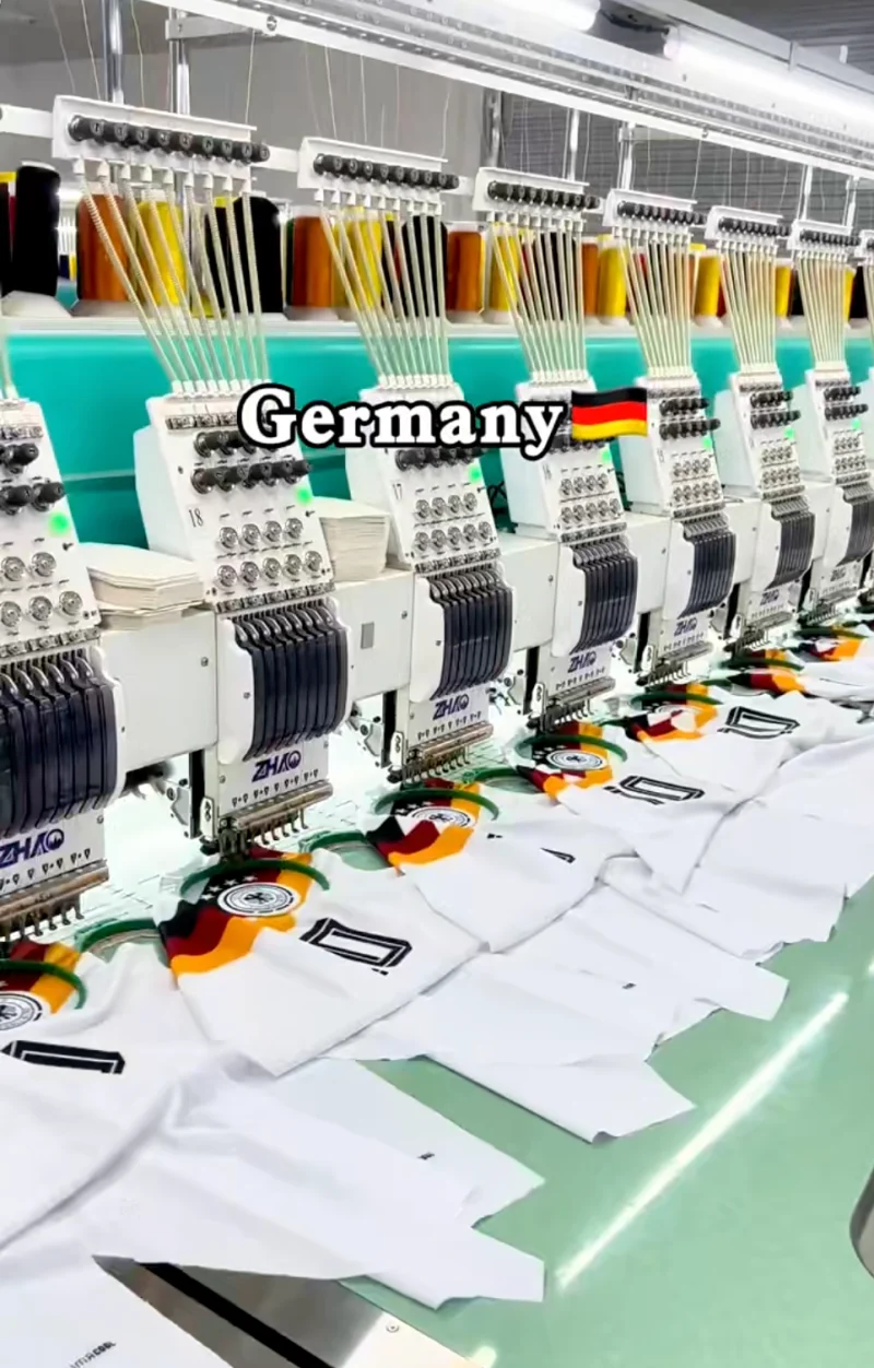 Multi-head embroidery machines working on white fabric.