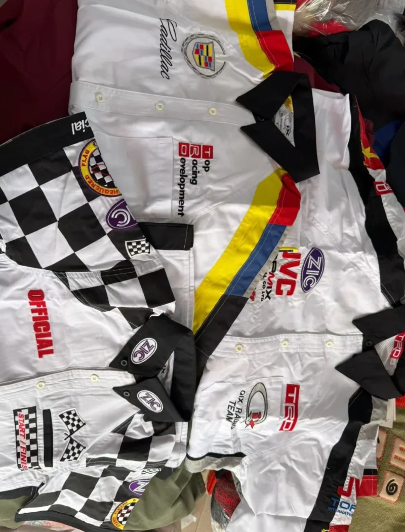 White shirts with black collars, checked panels, coloured stripes and emblems