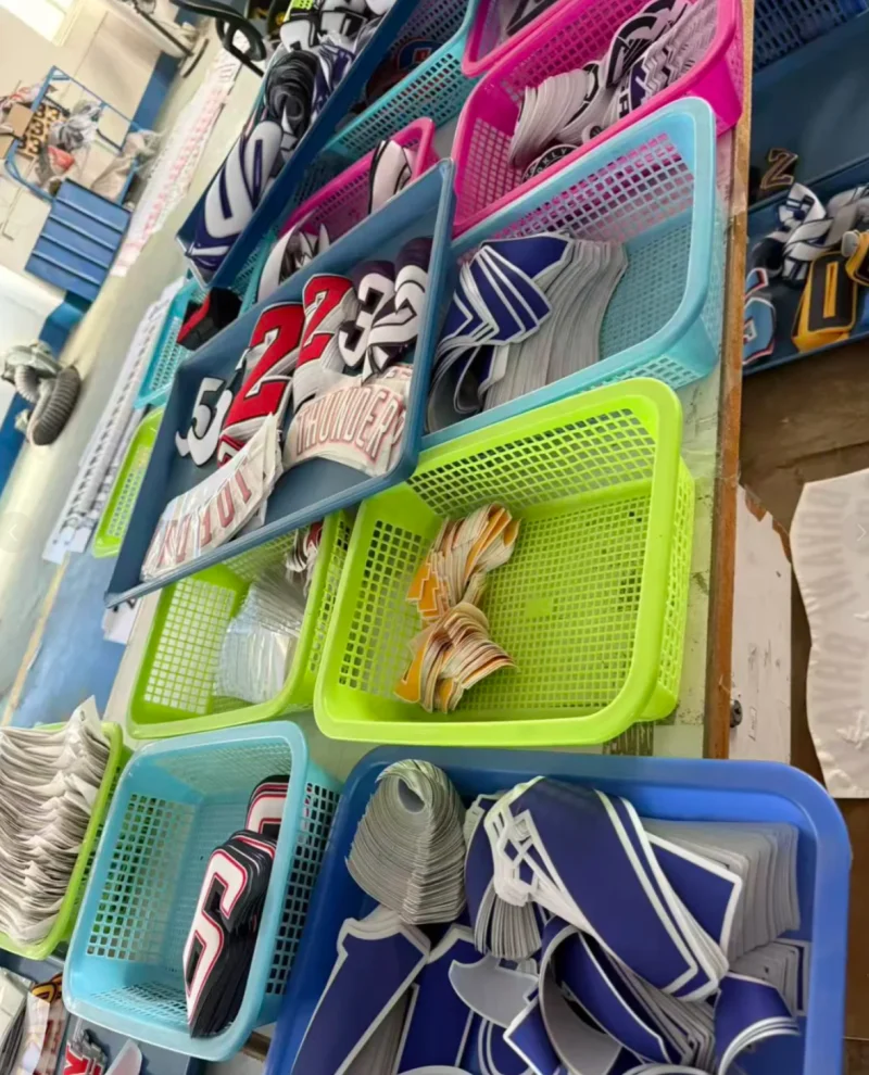 Green, pink and blue baskets containing stacked number and lettering components