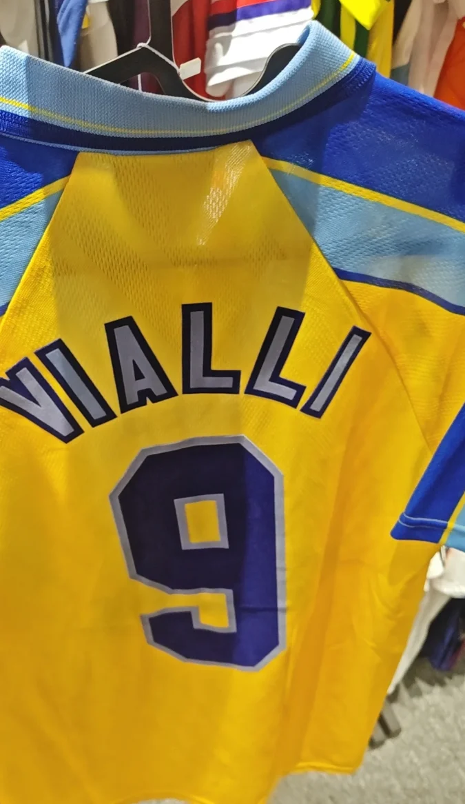 Collar and print detail on a yellow and blue jersey.